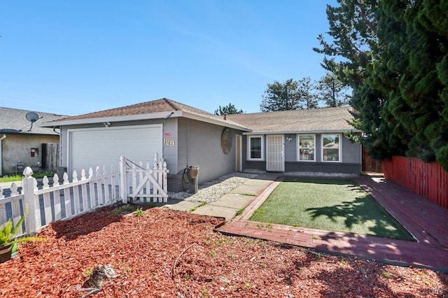 single story home featuring a front lawn, an attached garage, and fence