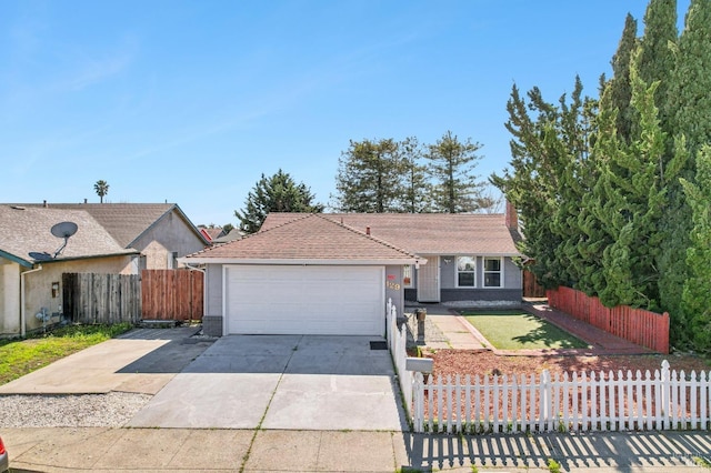 single story home featuring a garage, brick siding, driveway, and fence