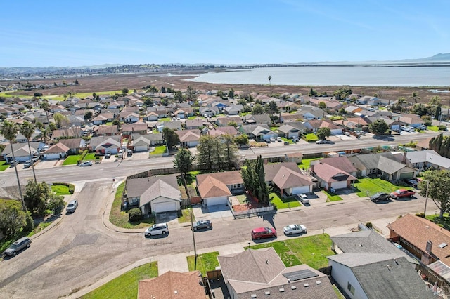 drone / aerial view featuring a residential view and a water view