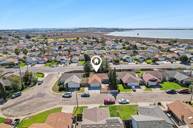 bird's eye view with a residential view and a water view