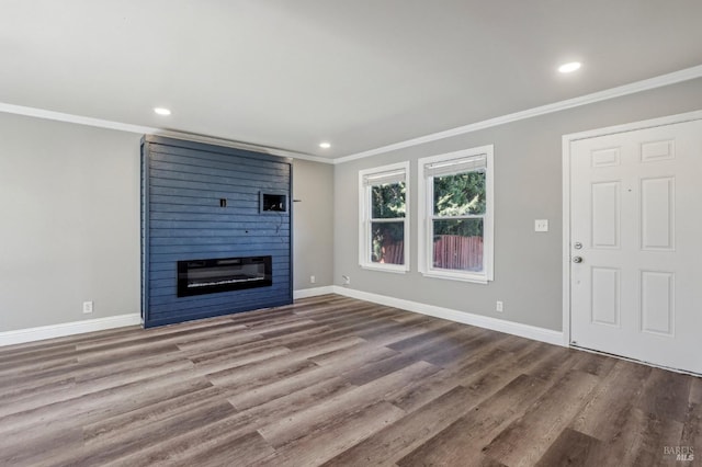 unfurnished living room featuring baseboards, ornamental molding, and a fireplace