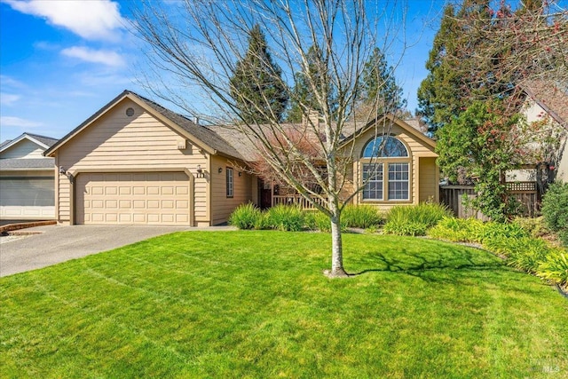 ranch-style home with driveway, an attached garage, fence, and a front yard