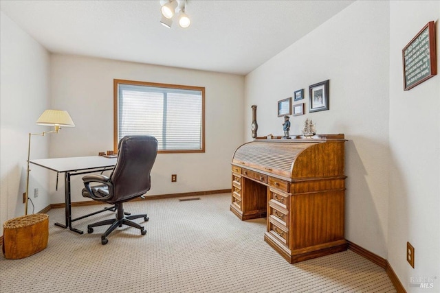 office space with baseboards, visible vents, and light colored carpet