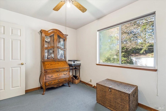 interior space with ceiling fan, baseboards, and carpet flooring