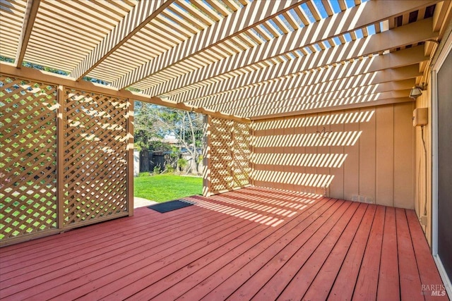 wooden terrace with a lawn and a pergola