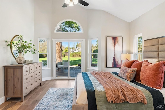 bedroom featuring light wood-style floors, access to outside, high vaulted ceiling, and baseboards