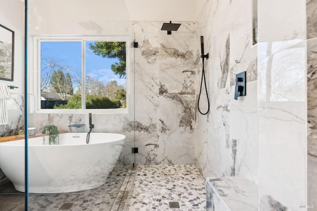 bathroom with a soaking tub, tile walls, and a marble finish shower