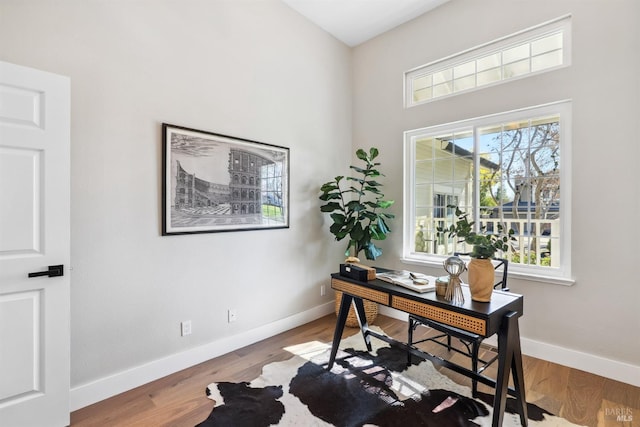 office with plenty of natural light, baseboards, and wood finished floors
