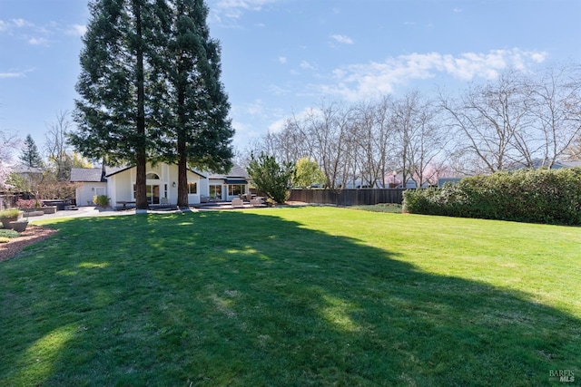 view of yard with fence and a patio