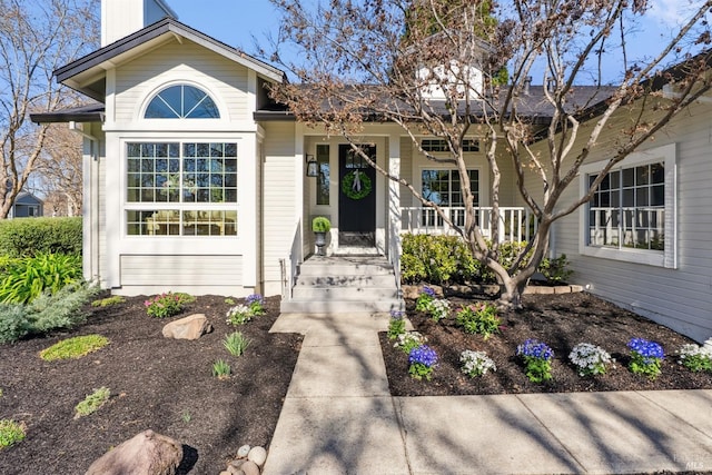 view of exterior entry with covered porch