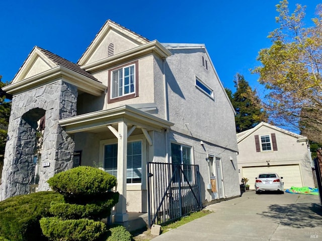 view of property exterior with a garage, stone siding, and stucco siding