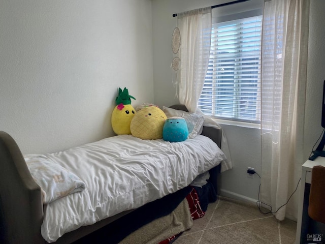 carpeted bedroom featuring baseboards