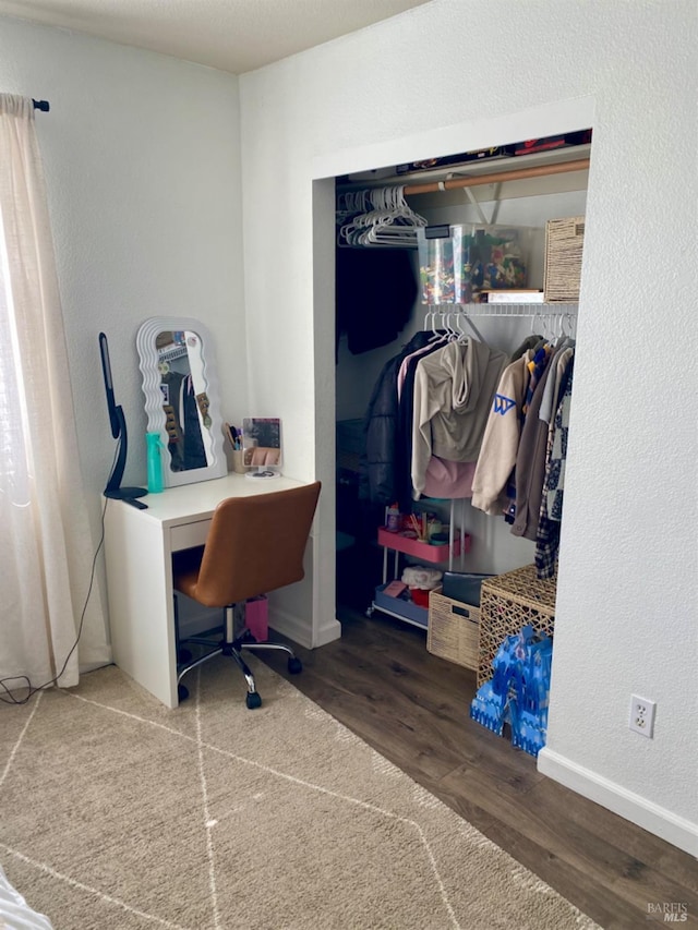 home office with baseboards, wood finished floors, and a textured wall