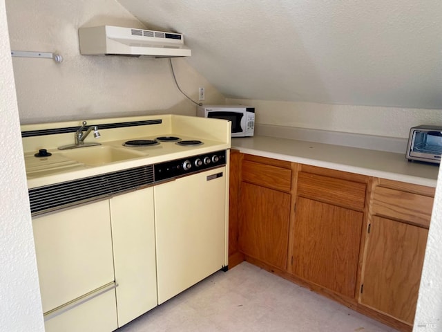 kitchen featuring lofted ceiling, white microwave, extractor fan, a textured ceiling, and light countertops