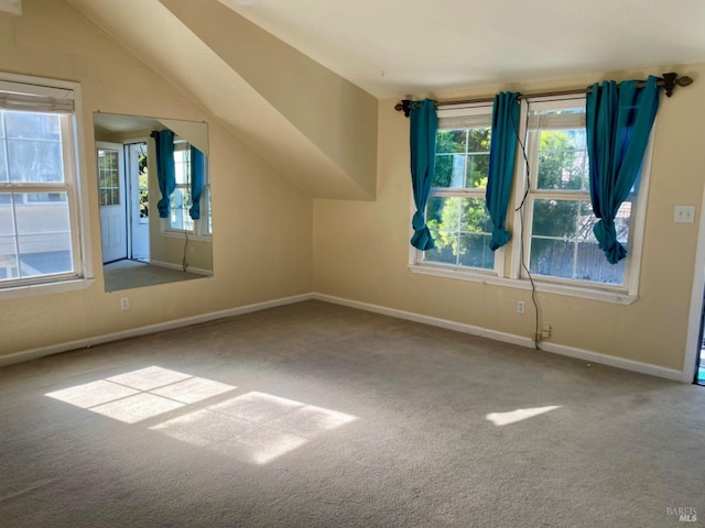 bonus room featuring a wealth of natural light, carpet flooring, lofted ceiling, and baseboards