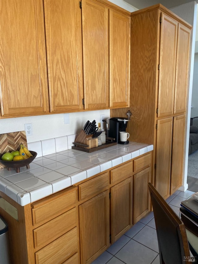 kitchen with light countertops and light tile patterned flooring