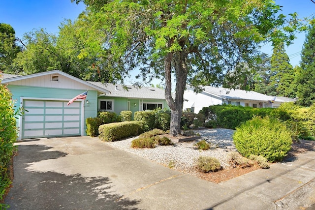 single story home featuring a garage and concrete driveway