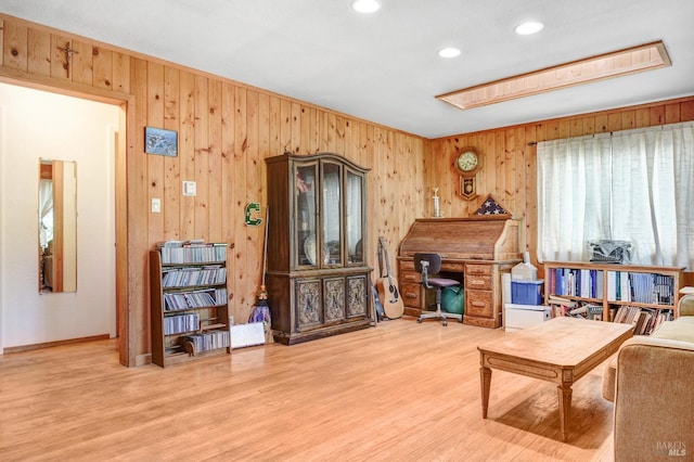 living area featuring recessed lighting, wooden walls, and wood finished floors