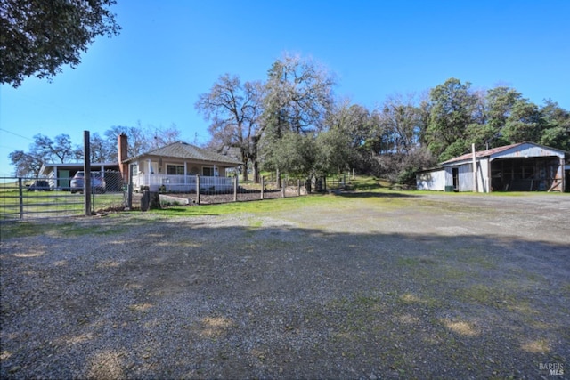 view of yard with fence and a detached carport