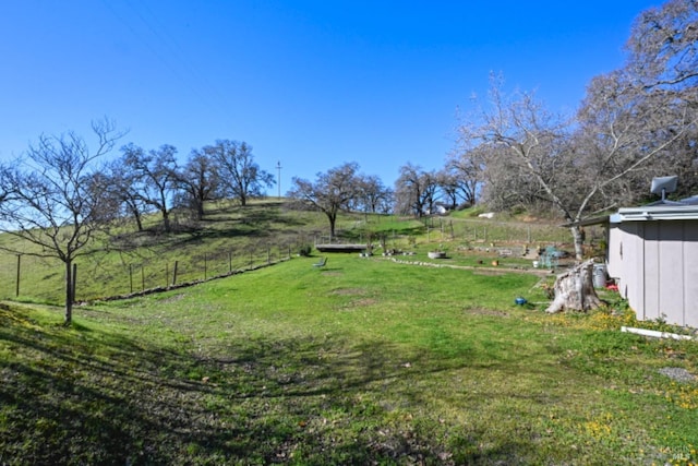 view of yard featuring a rural view and fence