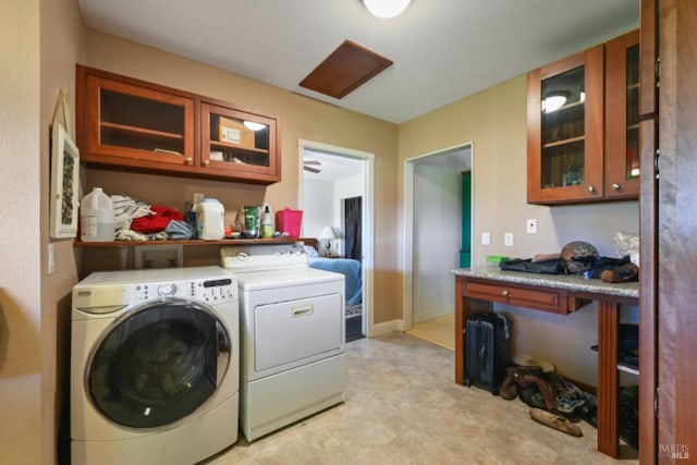 laundry room featuring laundry area, separate washer and dryer, light floors, and baseboards