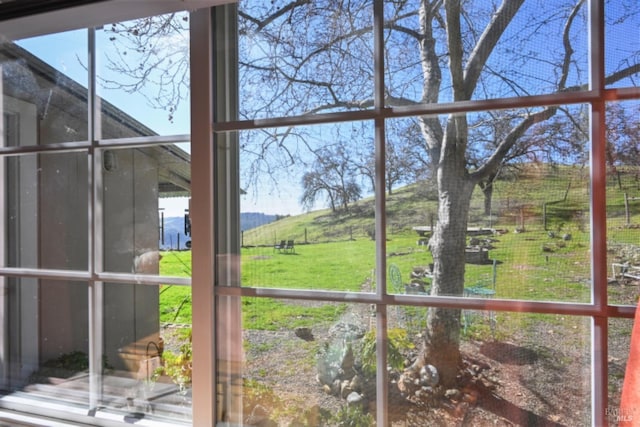 unfurnished sunroom featuring a rural view