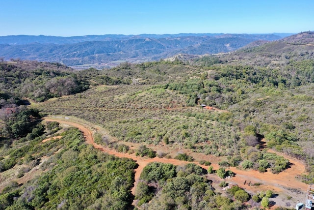 aerial view featuring a forest view and a mountain view