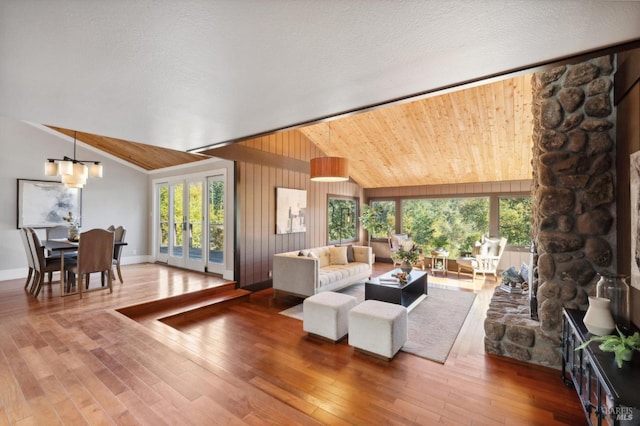 living room featuring lofted ceiling, hardwood / wood-style flooring, and a textured ceiling