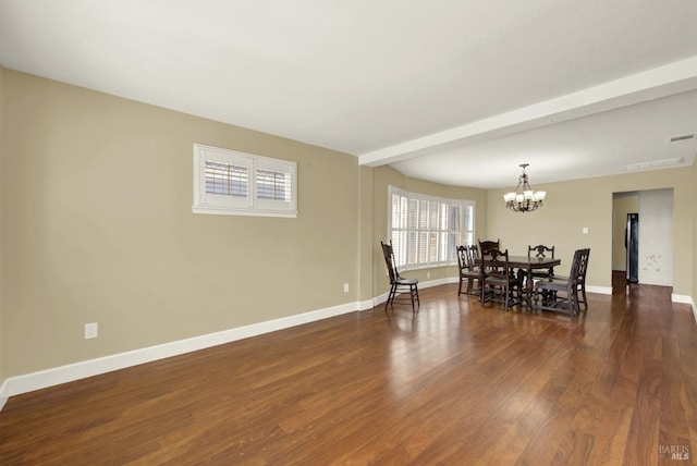 dining area featuring a chandelier, beam ceiling, baseboards, and wood finished floors