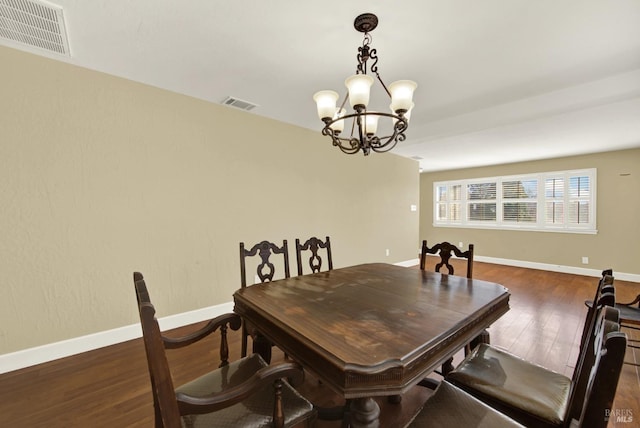 dining space featuring visible vents, baseboards, and wood finished floors