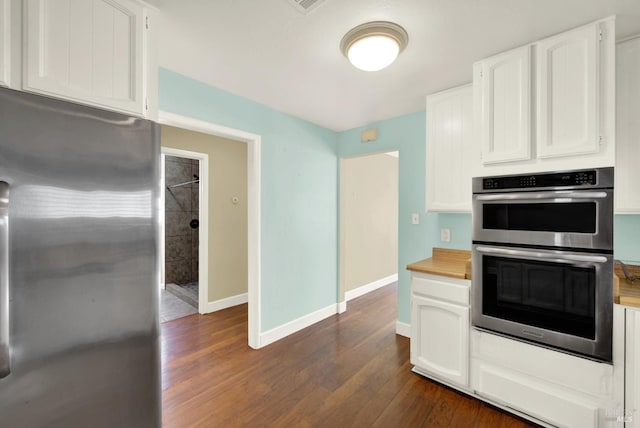 kitchen featuring dark wood-style floors, white cabinetry, and stainless steel appliances