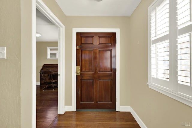 entrance foyer featuring dark wood-style floors and baseboards