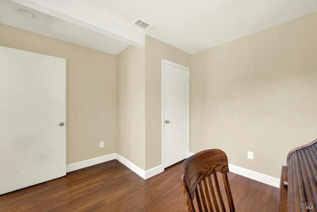 sitting room with baseboards, visible vents, and wood finished floors