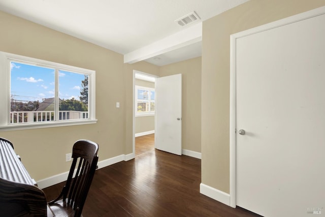 office featuring beam ceiling, visible vents, baseboards, and wood finished floors