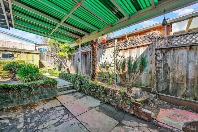 view of patio featuring fence