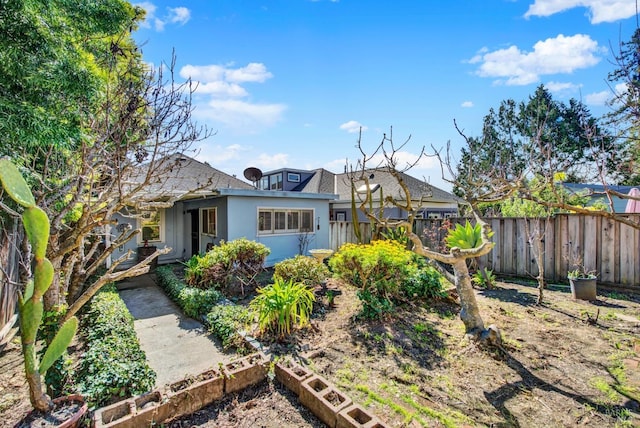 exterior space with fence and stucco siding