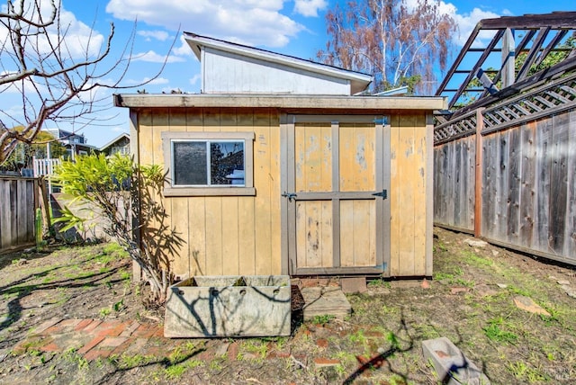 view of shed with a fenced backyard