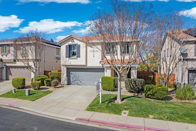 view of front of property with fence, a tile roof, concrete driveway, stucco siding, and a garage