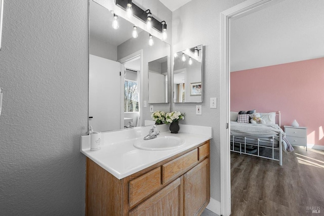 bathroom featuring vanity and a textured wall