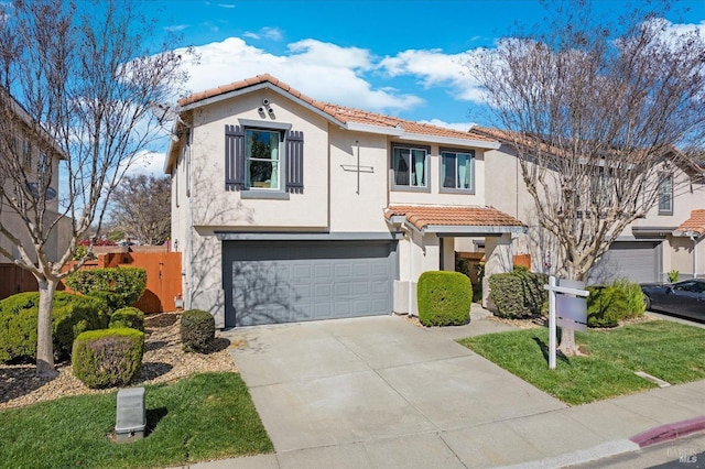 mediterranean / spanish house featuring stucco siding, driveway, an attached garage, and a tiled roof