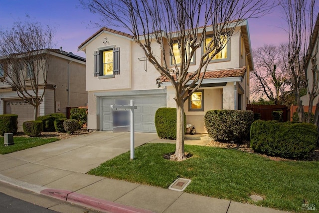 view of front facade featuring a tiled roof, a garage, concrete driveway, and stucco siding