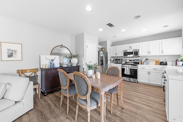 dining room featuring visible vents, recessed lighting, and light wood-style floors