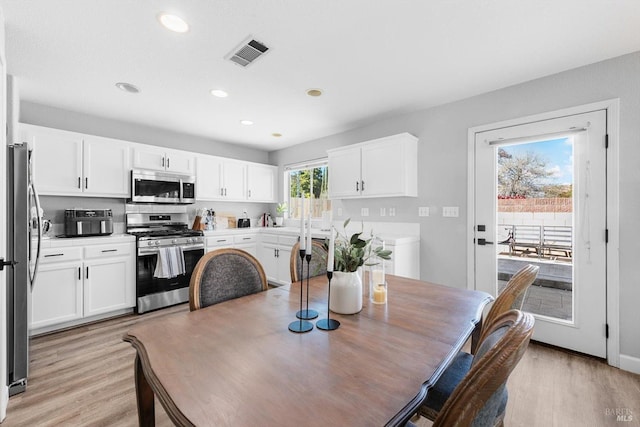 dining space featuring light wood-style flooring, recessed lighting, and visible vents