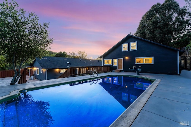 view of pool featuring a patio, a wooden deck, a fenced in pool, and fence