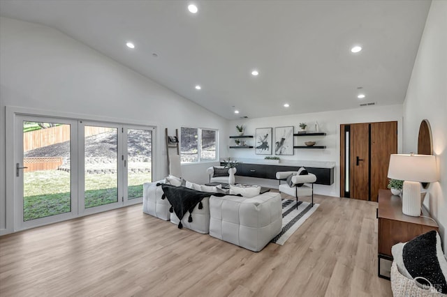 living area with light wood finished floors, plenty of natural light, and visible vents