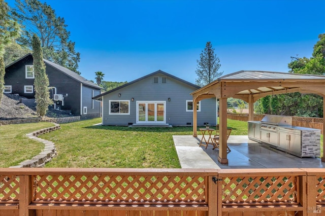 back of house with fence private yard, a patio area, a lawn, and area for grilling