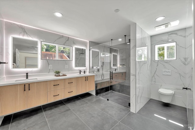 full bath with a sink, visible vents, tile walls, a marble finish shower, and double vanity