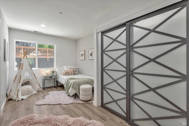 bedroom featuring visible vents and light wood finished floors