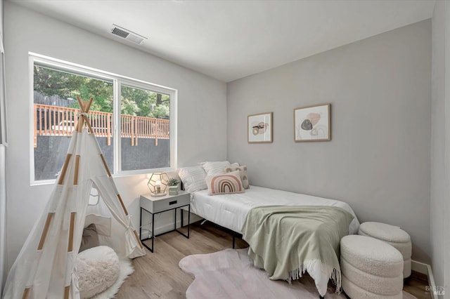 bedroom with wood finished floors and visible vents