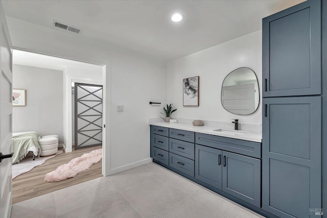 bathroom with baseboards, visible vents, connected bathroom, tile patterned flooring, and vanity